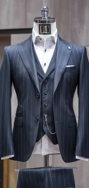 Navy striped slim fit three-piece suit on mannequin