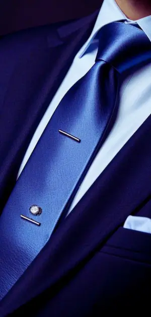 Formal silk ties for men displayed with a matching tie clip