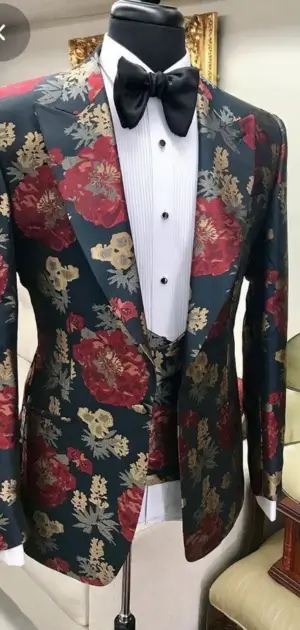 Men’s floral blazer features a dark green base with bold red and gold designs.