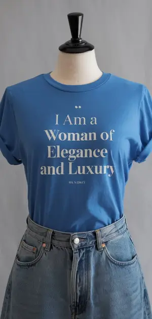 Blue t-shirt with "I Am a Woman of Elegance and Luxury" text