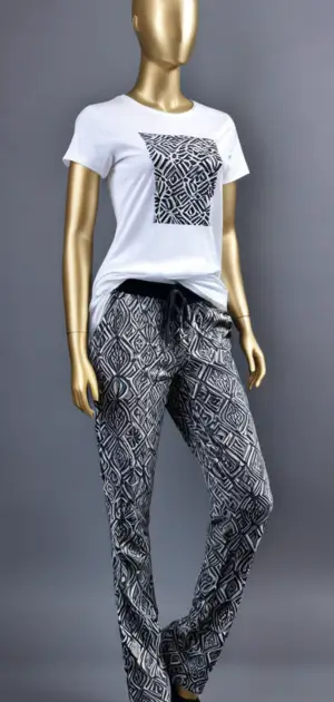 Mannequin dressed in a white t-shirt with black geometric print and patterned pants