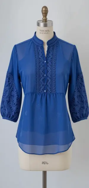 Blue blouse for women featuring delicate lace patterns and three-quarter sleeves.