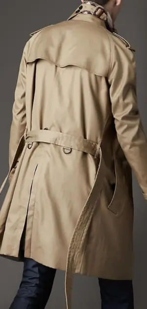 Beige trench coat with traditional back details and belt for adjustment.