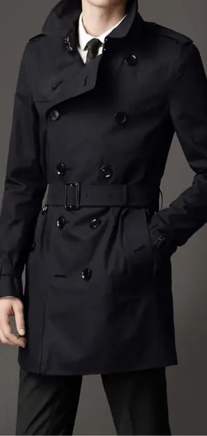 Black trench coat featuring double-breasted buttons and a belt.