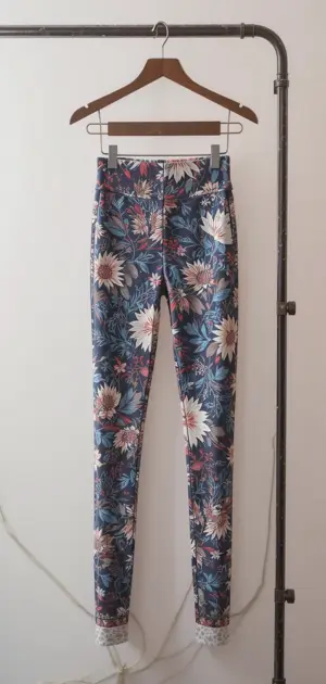 Blue floral-printed leggings with a high waist and a fitted style.