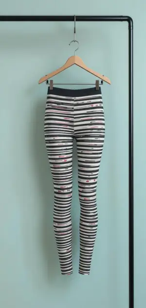 Black and white striped leggings with fitted high-waist and red details.