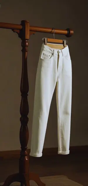 Curvy woman in mid-rise white bootcut jeans and heels