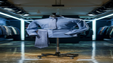 Blue formal shirt with a dotted tie displayed in a modern showroom
