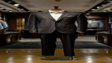 Elegant pinstriped suit displayed on a mannequin in a luxury store.