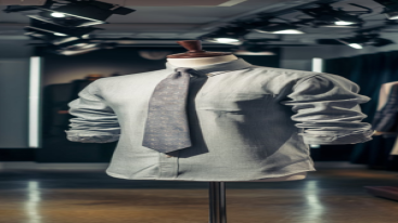 Light gray formal shirt with a patterned tie displayed in a fashion showroom