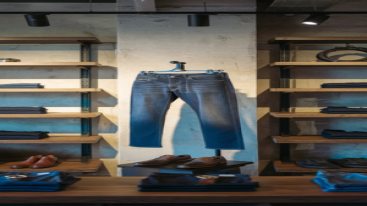 Light-wash party jeans displayed with matching accessories in a contemporary store