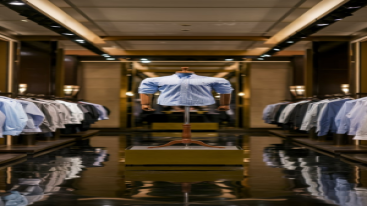 Single formal blue dress shirt on a mannequin in a premium retail store