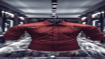Red dress shirt on a hanger in a luxury showroom aisle
