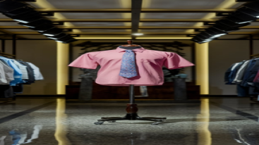 Pink summer formal shirt with floral tie on a mannequin