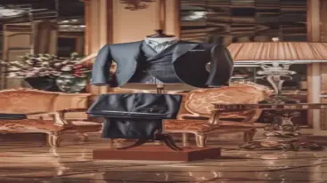 Pinstriped black formal suit displayed in a luxurious interior setting