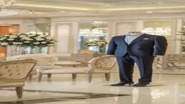 Navy blue wedding suit paired with a light gray shirt, displayed in a classy interior
