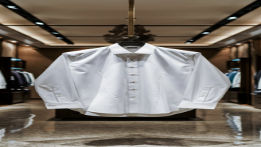 White dress shirt displayed in a luxury store aisle.
